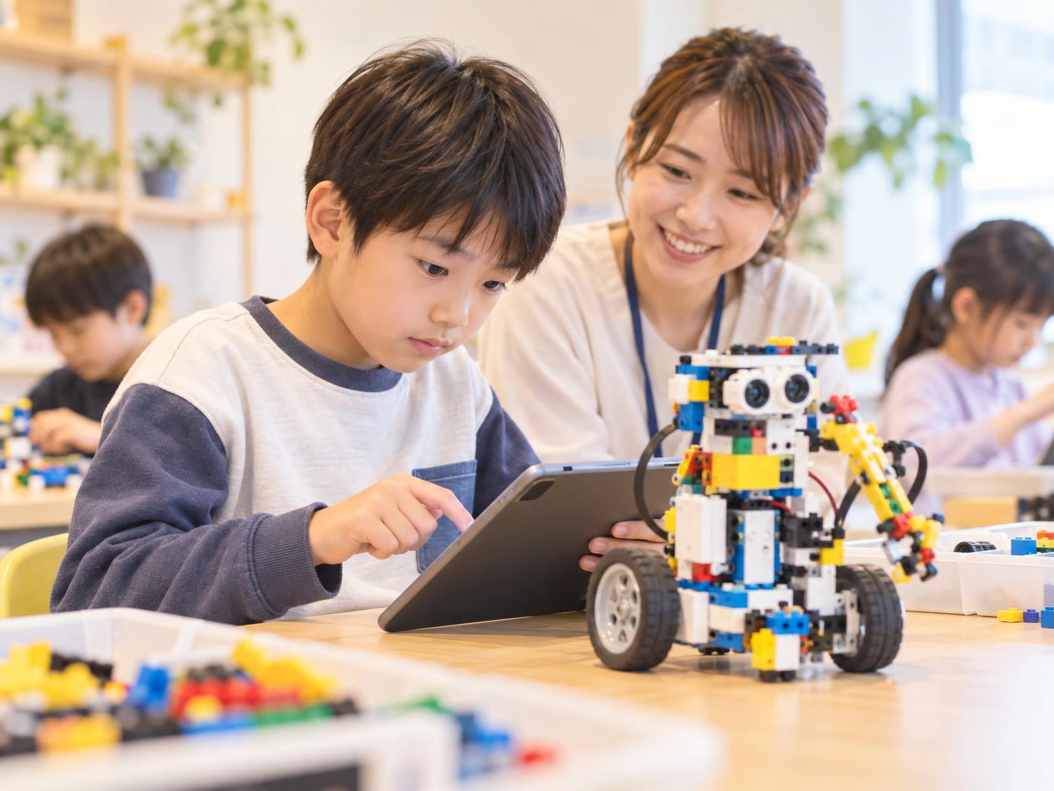 子どもがLEGOロボットをプログラミングしている様子