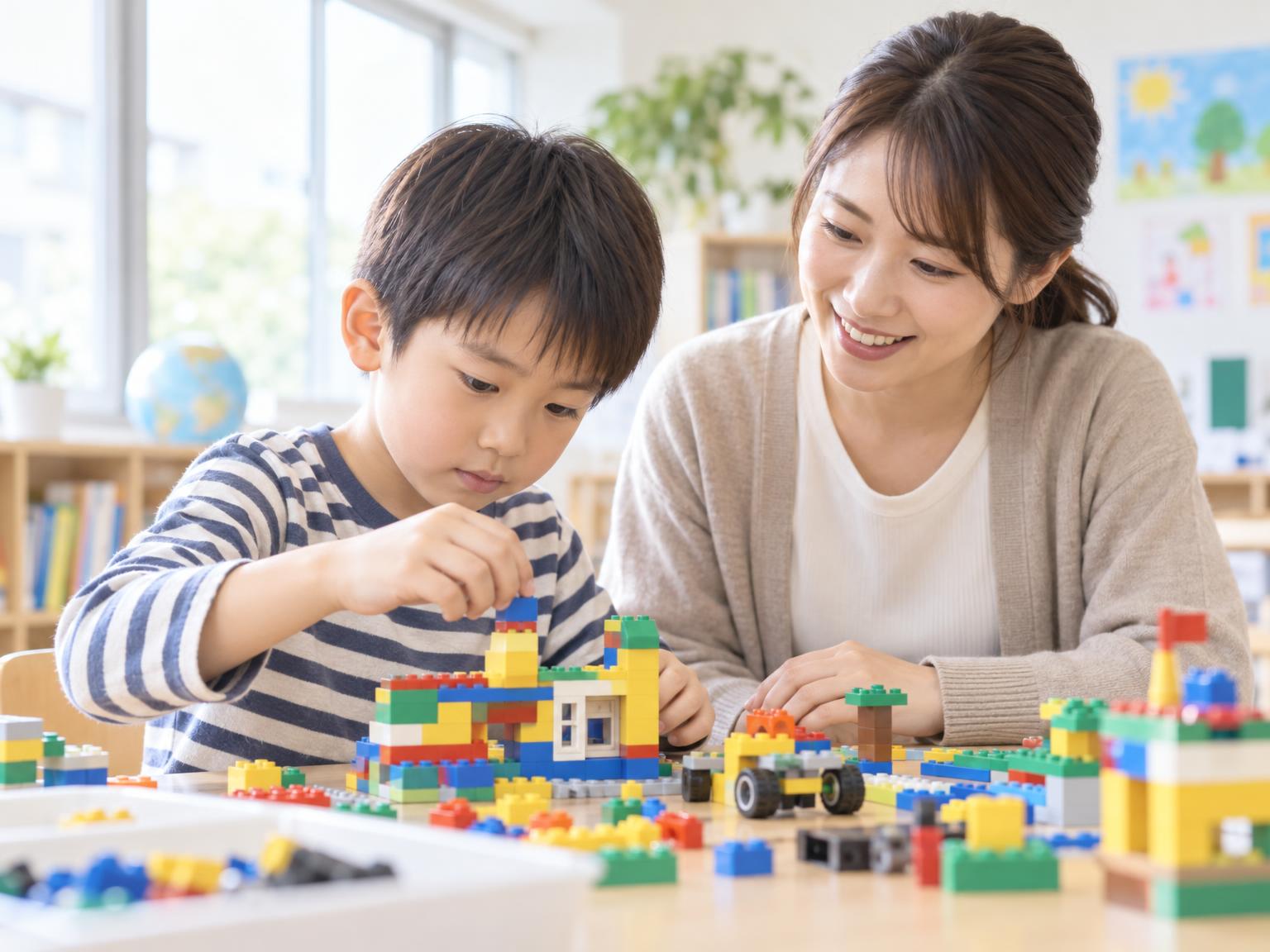 小学生がレゴブロックを使って課題に取り組む様子
